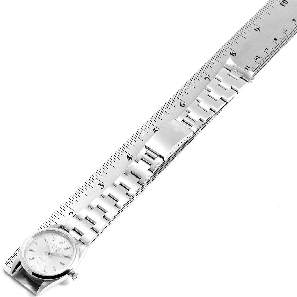 The Rolex Air-King 14000 Men's Stainless Steel Silver Dial 14000 Men's Stainless Steel Silver Dial watch is shown from a top-down angle with the entire watch and bracelet laid out next to a ruler for scale.
