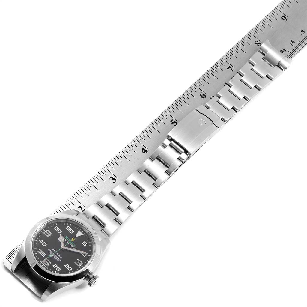 The image shows a top-down view of a Rolex Air-King 116900 Men's Stainless Steel Black Dial 116900 Men's Stainless Steel Black Dial watch, displaying its face, bezel, crown, and bracelet next to a ruler for measurement.