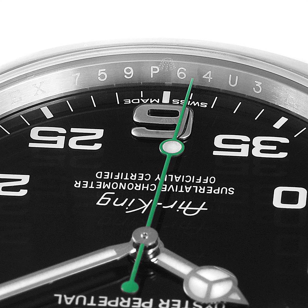 This image shows a close-up of the dial of a Rolex Air-King 116900 Men's Stainless Steel Black Dial 116900 Men's Stainless Steel Black Dial watch, highlighting the green second hand and part of the hour and minute hands.