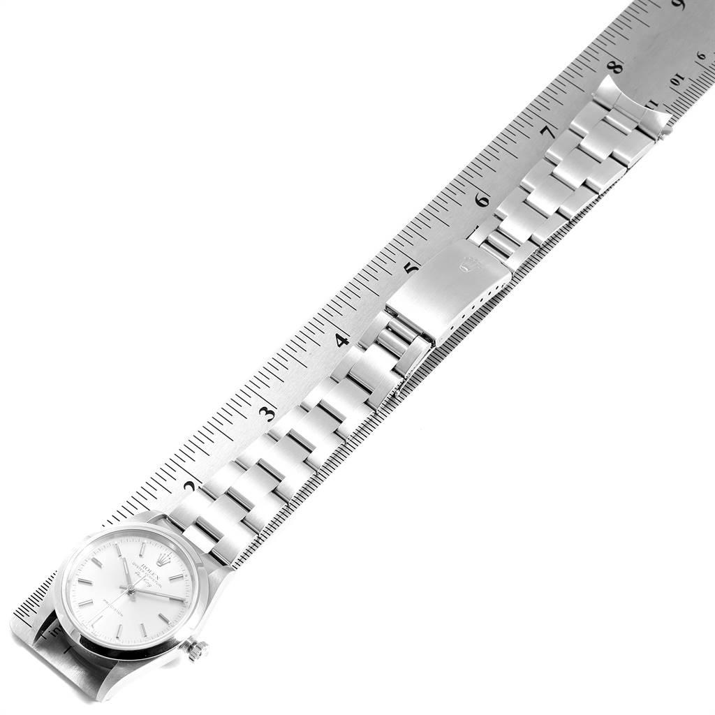 The image shows an overhead view of a Rolex Air-King 14000 Men's Stainless Steel Silver Dial 14000 Men's Stainless Steel Silver Dial watch with its metal bracelet laid alongside a ruler.