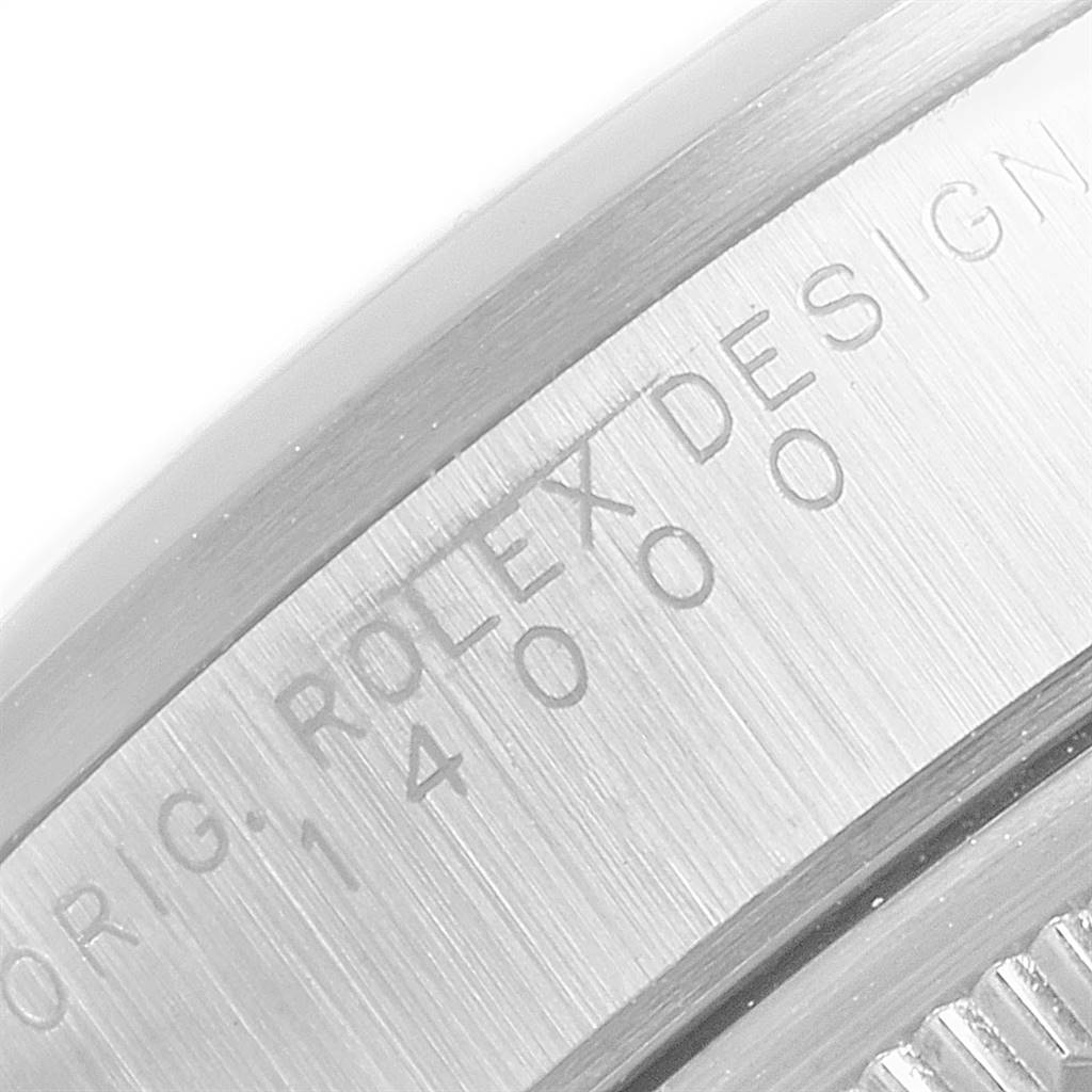 This image shows a close-up of the Rolex Air-King 14000 Men's Stainless Steel Silver Dial 14000 Men's Stainless Steel Silver Dial watch's stainless steel casing with engraved text.
