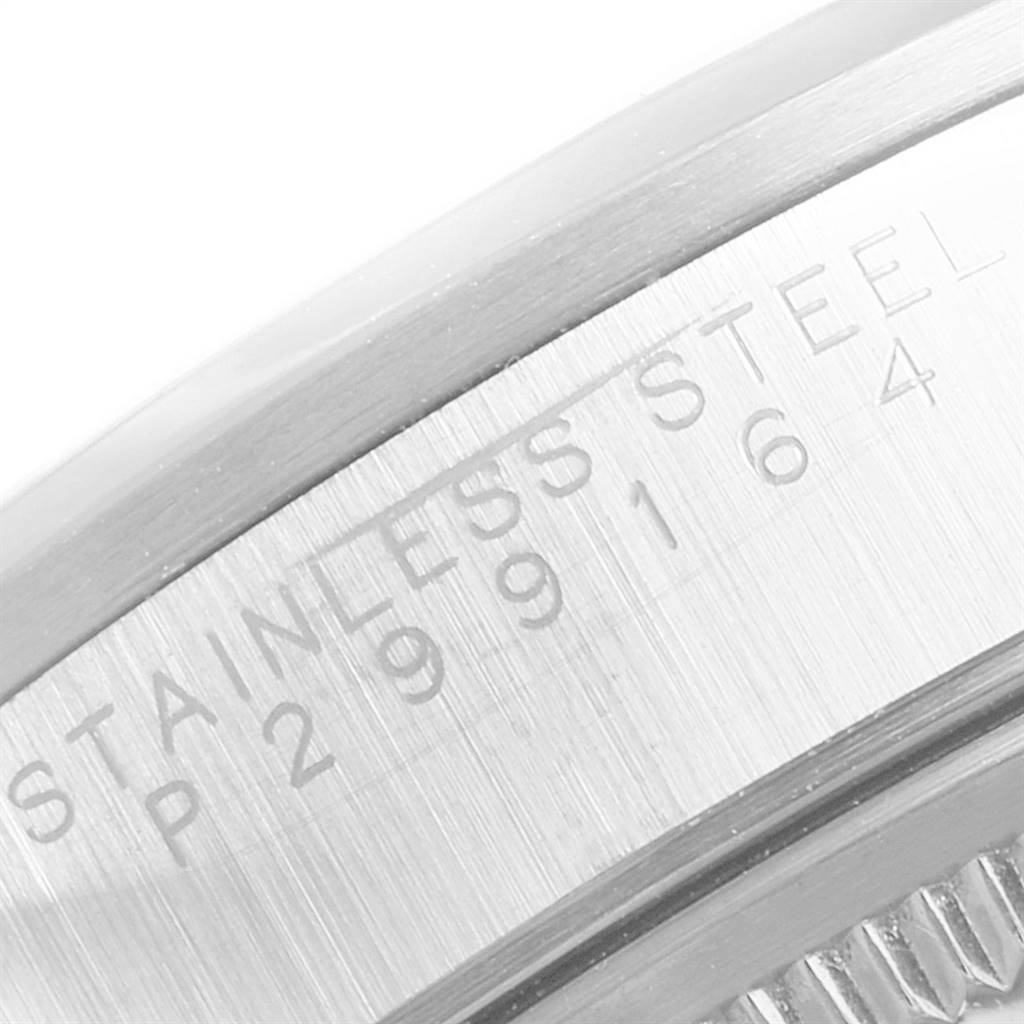 This image shows a close-up of the engraved serial number and "STAINLESS STEEL" wording on the side of a Rolex Air-King 14000 Men's Stainless Steel Silver Dial 14000 Men's Stainless Steel Silver Dial watch's case.