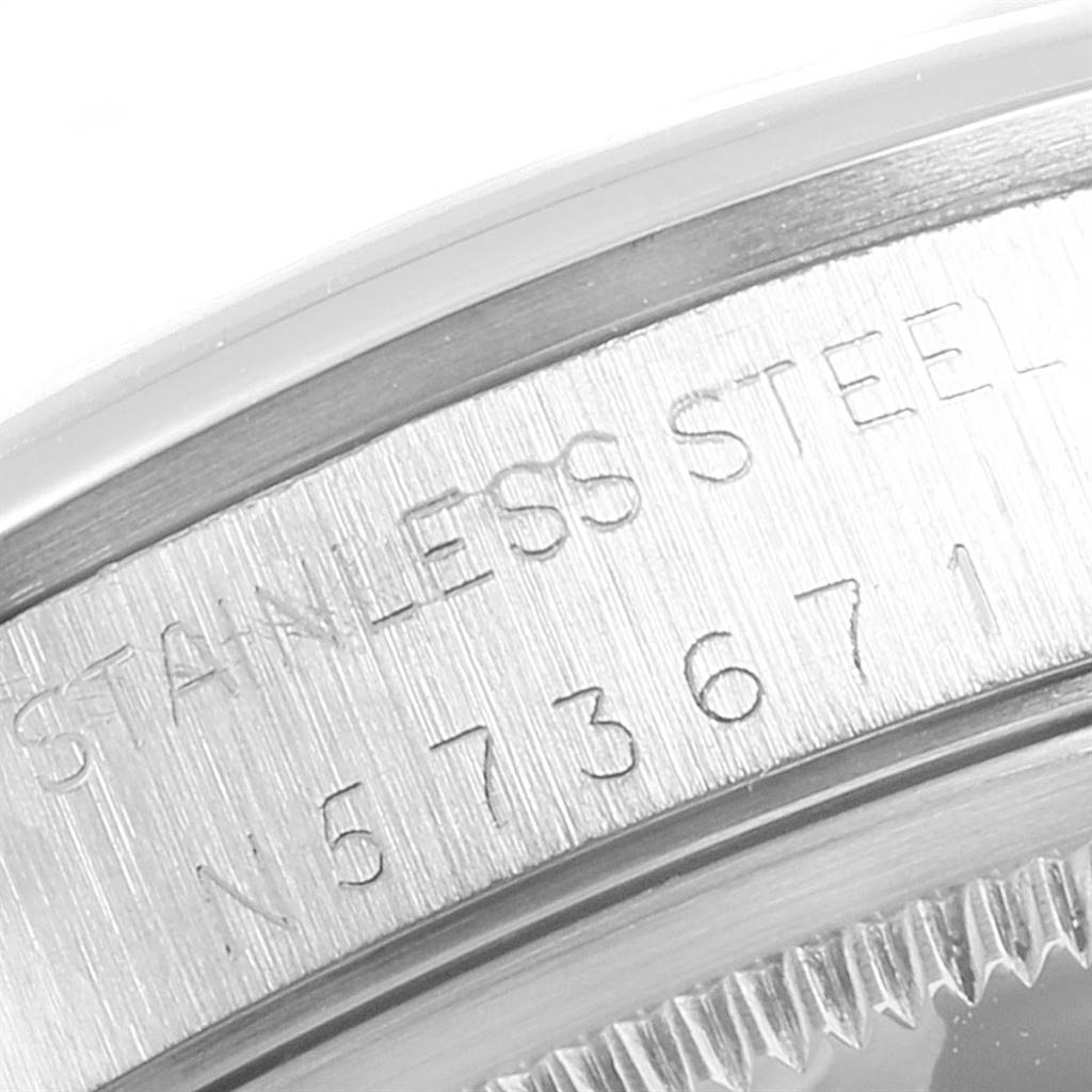 This is a close-up view of the back casing of a Rolex Air-King 14000 Men's Stainless Steel Black Dial 14000 Men's Stainless Steel Black Dial watch, showcasing the stainless steel material and part of the serial number.