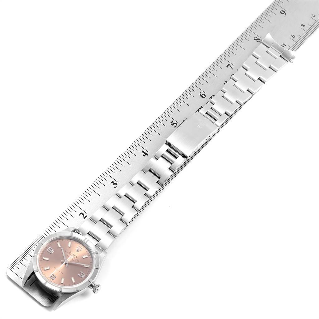 The image shows a Rolex Air-King 14010 Men's Stainless Steel Pink Dial 14010 Men's Stainless Steel Pink Dial watch laid flat alongside a ruler, highlighting the watch face and full bracelet length.