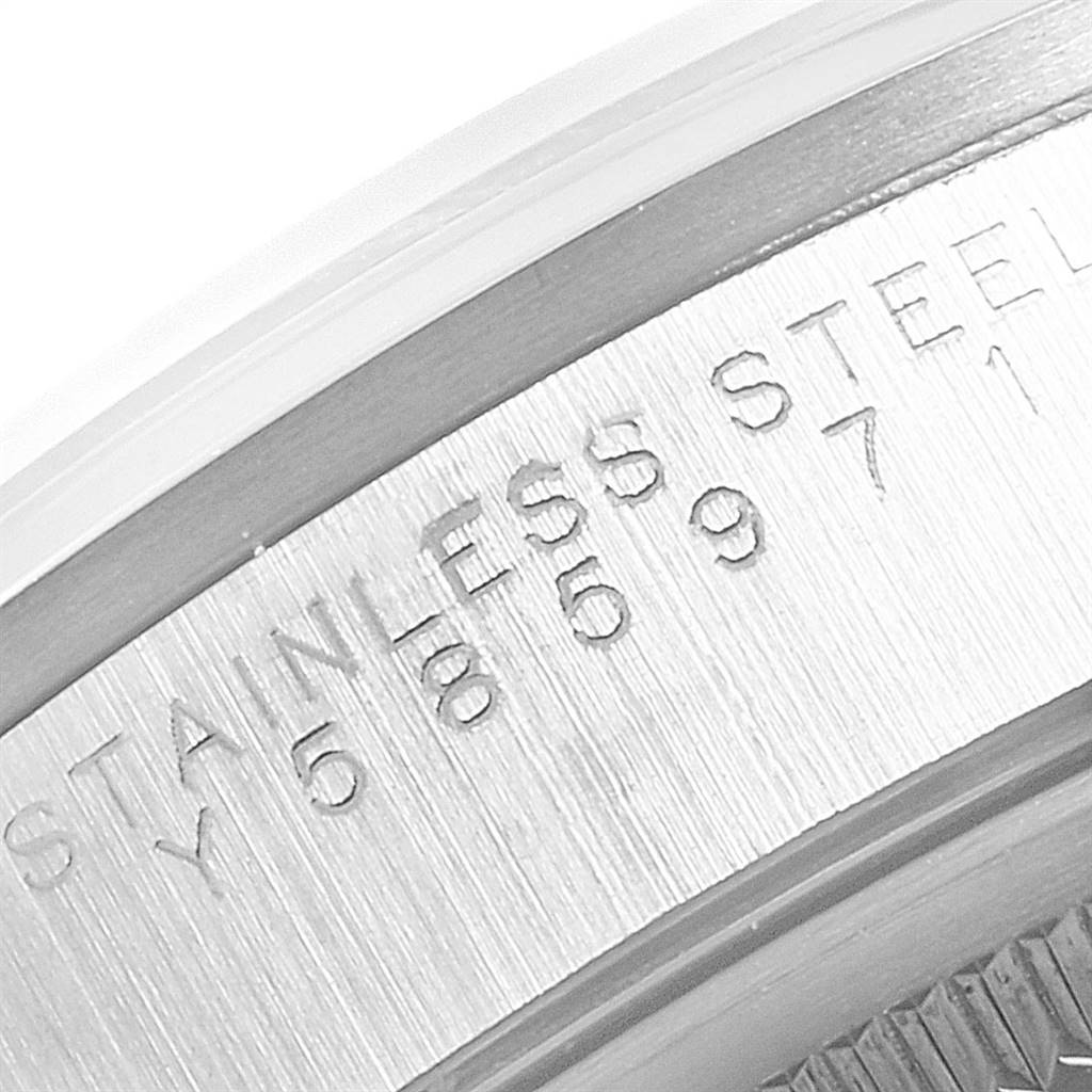 This close-up image shows a portion of the stainless steel casing of a Rolex Air-King 14000 Men's Stainless Steel Silver Dial 14000 Men's Stainless Steel Silver Dial watch, highlighting engraved text and serial numbers.