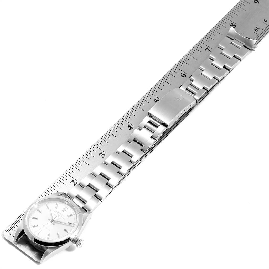 The image shows a Rolex Air-King 14000 Men's Stainless Steel Silver Dial 14000 Men's Stainless Steel Silver Dial watch at a top-down angle, displaying the watch face, crown, and metal bracelet clasp laid against a ruler.