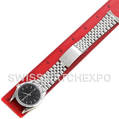 This image of a Rolex Air-King 14010 Men's Stainless Steel Black Dial 14010 Men's Stainless Steel Black Dial watch shows it horizontally placed on a red ruler, displaying the face and metal bracelet.
