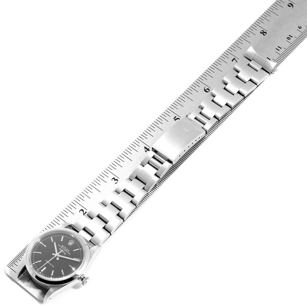 The image shows a Rolex Air-King 14000 Men's Stainless Steel Black Dial 14000 Men's Stainless Steel Black Dial watch, angled diagonally, displaying the bracelet and clasp along a ruler.