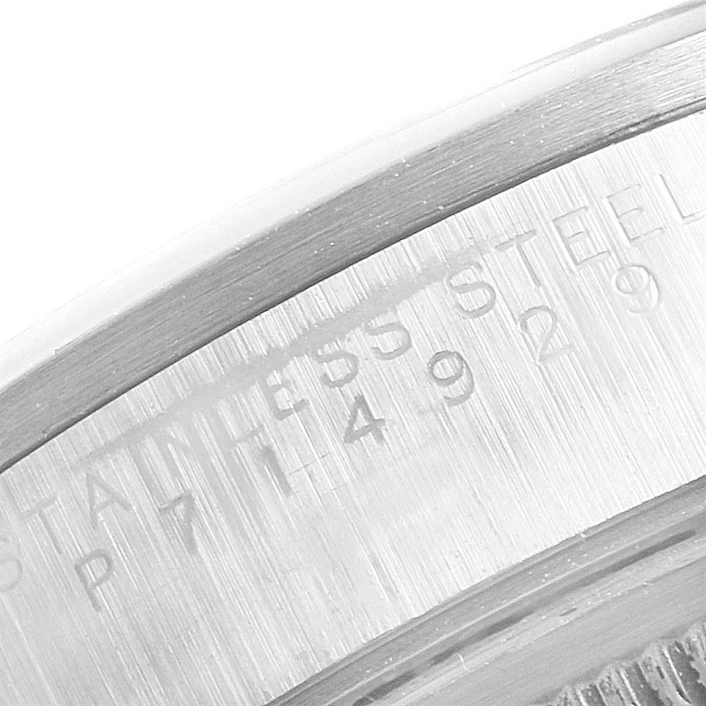 The image shows a close-up of the engraved edge of the case back of a Rolex Air-King 14000 Men's Stainless Steel Black Dial 14000 Men's Stainless Steel Black Dial stainless steel watch from a side angle.