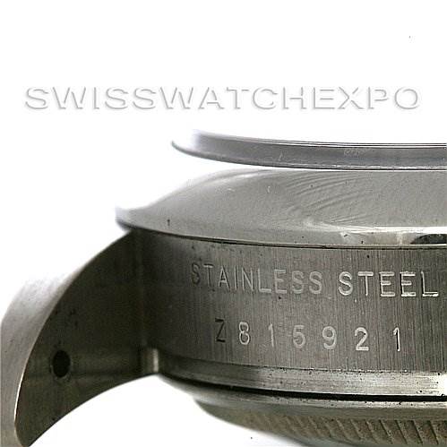 The image shows a close-up view of the side of a Rolex Air-King 114200 Men's Stainless Steel White Dial 114200 Men's Stainless Steel White Dial watch, focusing on the stainless steel case and serial number.
