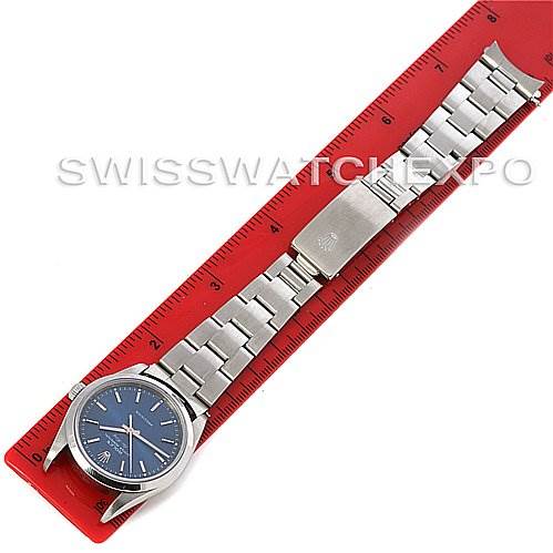 The image shows a top-down view of the Rolex Air-King 14000M Men's Stainless Steel Blue Dial 14000M Men's Stainless Steel Blue Dial watch laid flat on a red ruler.