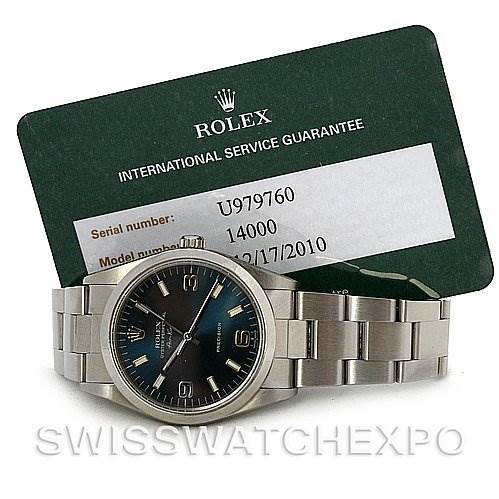 The image shows a full frontal view of the Rolex Air-King 14000 Men's Stainless Steel Blue Dial 14000 Men's Stainless Steel Blue Dial watch with a metal bracelet and an international service guarantee card.