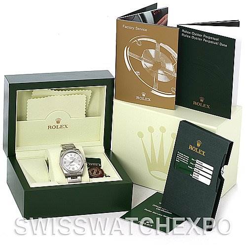 The image shows a Rolex Air-King 114200SASO Men's Stainless Steel Silver Dial 114200SASO Men's Stainless Steel Silver Dial watch packaged in its original box, with accompanying booklets and accessories displayed around it.