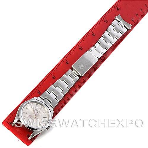 The Rolex Air-King 14000 M Men's Stainless Steel Silver Dial 14000 M Men's Stainless Steel Silver Dial watch is shown from a top-down angle, displaying the full bracelet and clasp beside a red ruler.
