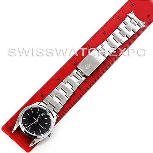The image shows a top-down view of a Rolex Air-King 14000 Men's Stainless Steel Black Dial 14000 Men's Stainless Steel Black Dial watch alongside a red ruler.