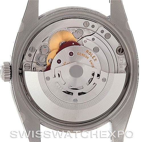 The image shows the back view of a Rolex Air-King 114200 Men's Stainless Steel Blue Dial 114200 Men's Stainless Steel Blue Dial watch, revealing the internal movement and mechanisms.