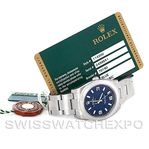 The image shows a Rolex Air-King 114200 Men's Stainless Steel Blue Dial 114200 Men's Stainless Steel Blue Dial watch at an angle displaying its face and bracelet, alongside its certification card and accessories.