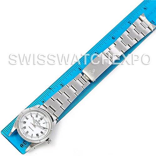 This image shows a top-down view of a Rolex Air-King 14010 Men's Stainless Steel White Dial 14010 Men's Stainless Steel White Dial watch, highlighting its face, bracelet, and clasp placed next to a ruler.