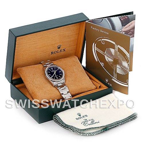 The image shows a Rolex Air-King 14010 Men's Stainless Steel Black Dial 14010 Men's Stainless Steel Black Dial watch inside its box, along with a manual and a cleaning cloth.