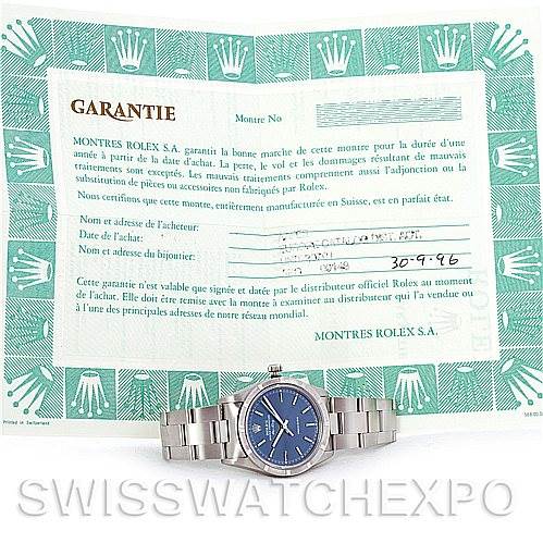 The image shows a Rolex Air-King 14010 Men's Stainless Steel Blue Dial 14010 Men's Stainless Steel Blue Dial watch with a blue dial and stainless steel bracelet, along with its guarantee document.