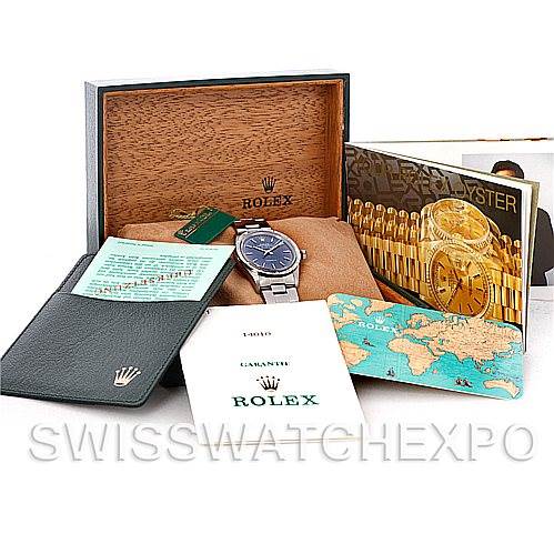 The image shows a Rolex Air-King 14010 Men's Stainless Steel Blue Dial 14010 Men's Stainless Steel Blue Dial watch with its accessories including a wooden box, booklets, a warranty card, and a tag.