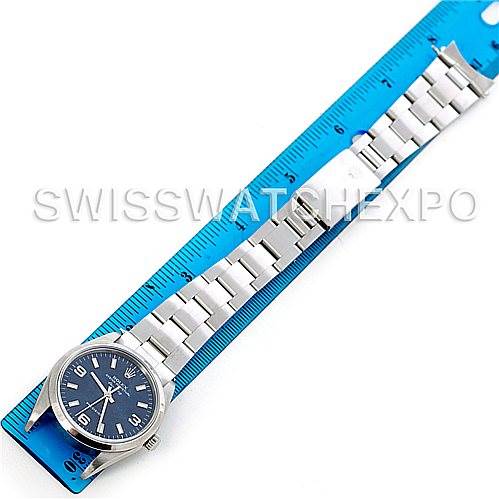 The image shows a Rolex Air-King 14000 Men's Stainless Steel Blue Dial 14000 Men's Stainless Steel Blue Dial watch laid flat on a blue ruler, highlighting the full stainless steel band and dial.