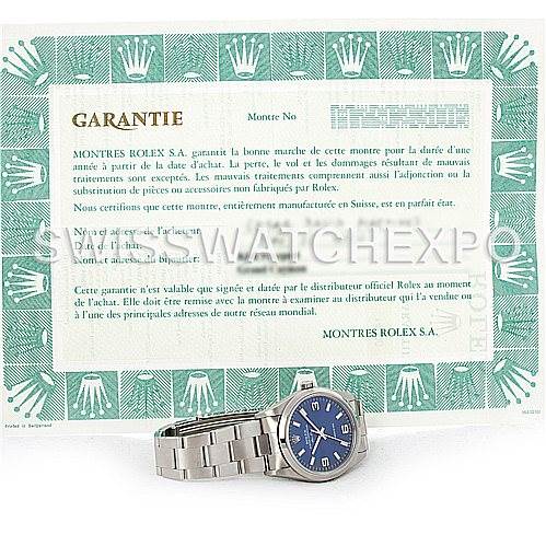 The image shows a Rolex Air-King 14000 Men's Stainless Steel Blue Dial 14000 Men's Stainless Steel Blue Dial watch positioned next to its warranty certificate.