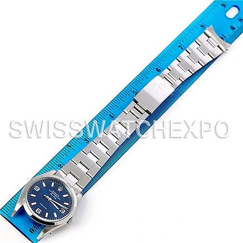 The image shows a full view of a Rolex Air-King 14000 Men's Stainless Steel Blue Dial 14000 Men's Stainless Steel Blue Dial watch placed next to a blue ruler for scale.