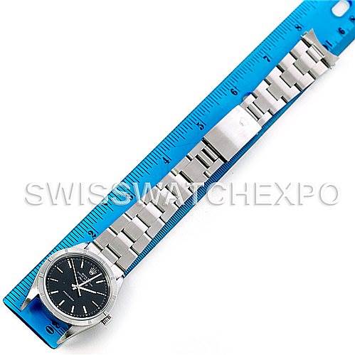 This image shows the Rolex Air-King 14010 Men's Stainless Steel Black Dial 14010 Men's Stainless Steel Black Dial watch lying flat next to a blue ruler, displaying the full bracelet and face.