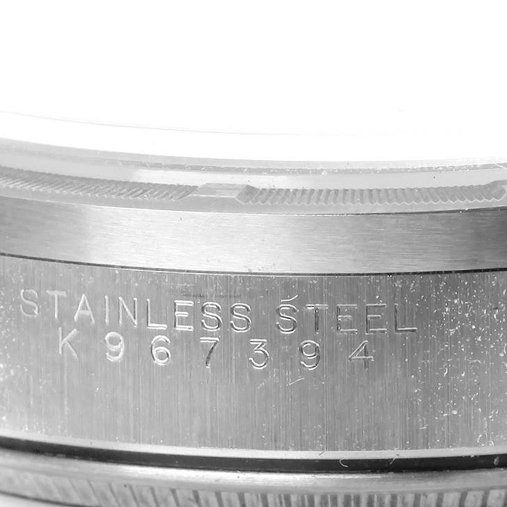The image shows a close-up of the stainless steel case and serial number of a Rolex Air-King 14010 Men's Stainless Steel Blue Dial 14010 Men's Stainless Steel Blue Dial watch.