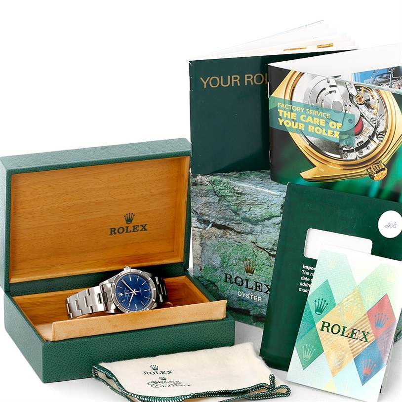 The image shows a Rolex Air-King 14010 Men's Stainless Steel Blue Dial 14010 Men's Stainless Steel Blue Dial watch in its box, surrounded by manuals, service booklets, and a cleaning cloth.