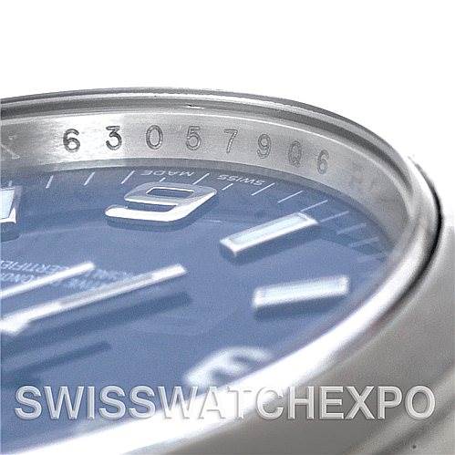 The image shows a close-up, angled view of the bezel and part of the dial of a Rolex Air-King 114200 Men's Stainless Steel Blue Dial 114200 Men's Stainless Steel Blue Dial watch, focusing on the engraved serial number.