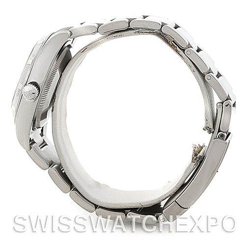 The image features a side view of the Rolex Air-King 114210 Men's Stainless Steel Silver Dial 114210 Men's Stainless Steel Silver Dial watch showing the case, crown, and parts of the bracelet.