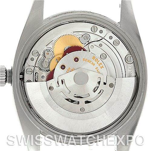 The image shows the backside of a Rolex Air-King 114210 Men's Stainless Steel Silver Dial 114210 Men's Stainless Steel Silver Dial watch, focusing on the intricate details of its internal mechanical parts.