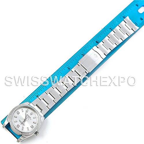 The image shows a Rolex Air-King 114210 Men's Stainless Steel Silver Dial 114210 Men's Stainless Steel Silver Dial watch placed next to a blue ruler, displaying the entire watch face and bracelet from an overhead view.