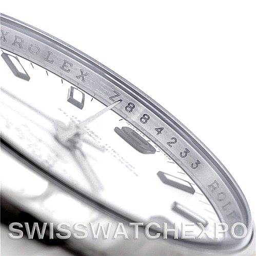 The image shows a close-up of the Rolex Air-King 114200 Men's Stainless Steel White Dial 114200 Men's Stainless Steel White Dial watch, focusing on the engraving around the bezel and part of the dial.