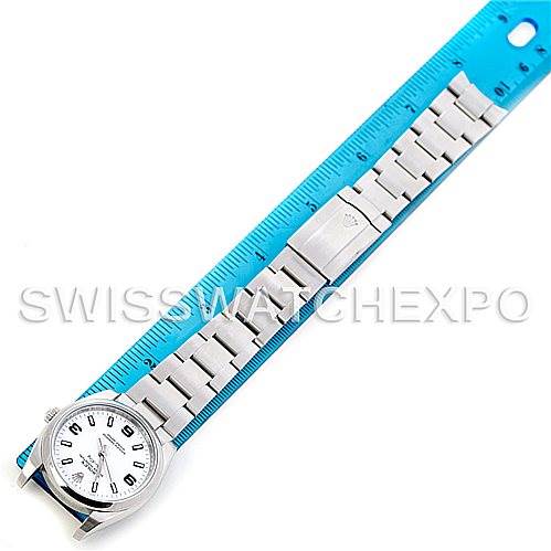 The image shows a top-down view of a Rolex Air-King 114200 Men's Stainless Steel White Dial 114200 Men's Stainless Steel White Dial watch, including the dial and the full length of the stainless steel bracelet alongside a ruler.