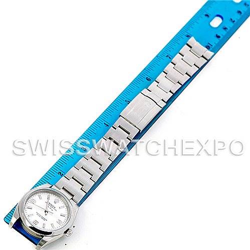 The Rolex Air-King 114200 Men's Stainless Steel Silver Dial 114200 Men's Stainless Steel Silver Dial watch is shown from a top-down angle, highlighting the face and the full length of its metal bracelet against a ruler.