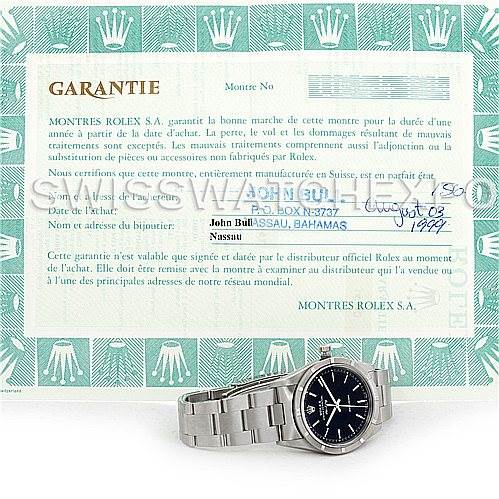The image shows a Rolex Air-King 14010 Men's Stainless Steel Black Dial 14010 Men's Stainless Steel Black Dial watch with a stainless steel bracelet, placed in front of a warranty certificate from Rolex.