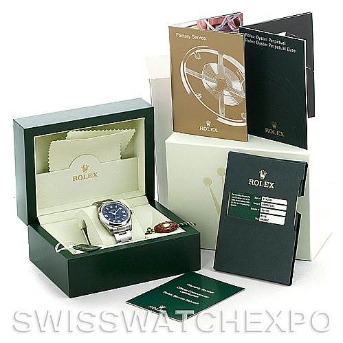 The image shows a Rolex Air-King 114200 Men's Stainless Steel Blue Dial 114200 Men's Stainless Steel Blue Dial watch in its case, with warranty cards, manuals, and a cleaning cloth.