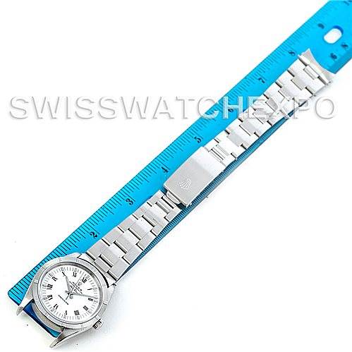 The image shows a top-down view of a Rolex Air-King 14010 Men's Stainless Steel White Dial 14010 Men's Stainless Steel White Dial watch placed next to a blue ruler, displaying its dial and metal bracelet.