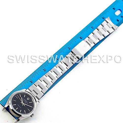 The Rolex Air-King 14000 Men's Stainless Steel Black Dial 14000 Men's Stainless Steel Black Dial watch is shown from a top-down view, displaying its face, bracelet, and clasp alongside a ruler for scale.