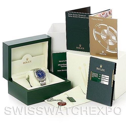 The image shows the Rolex Air-King 114200 Men's Stainless Steel Blue Dial 114200 Men's Stainless Steel Blue Dial watch at a front angle with its box, warranty card, booklets, cloth, and tag.