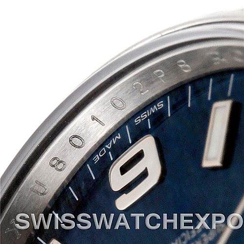 This close-up image of the Rolex Air-King 114200 Men's Stainless Steel Blue Dial 114200 Men's Stainless Steel Blue Dial watch showcases the bezel, part of the watch face, and the "Swiss Made" label.