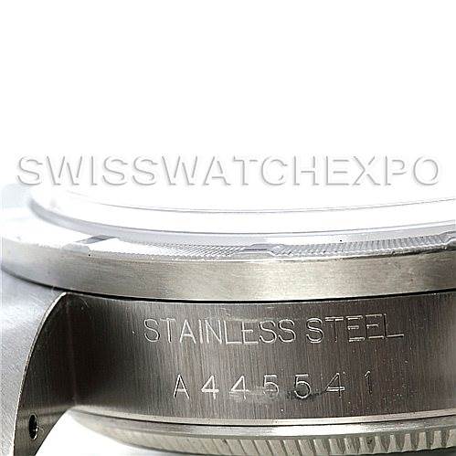 The image shows a close-up of the side of a Rolex Air-King 14010 Men's Stainless Steel Black Dial 14010 Men's Stainless Steel Black Dial watch, focusing on its stainless steel case and serial number.