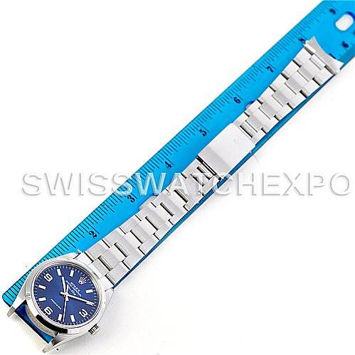 This image shows a Rolex Air-King 14000 Men's Stainless Steel Blue Dial 14000 Men's Stainless Steel Blue Dial watch laid flat with the face up, aligned next to a blue ruler for size reference.