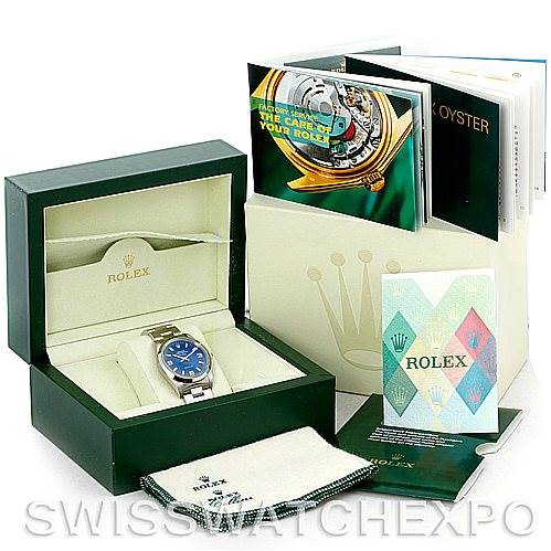 The image shows a Rolex Air-King 14000 Men's Stainless Steel Blue Dial 14000 Men's Stainless Steel Blue Dial watch in its open box with manuals, a cloth, and additional packaging.