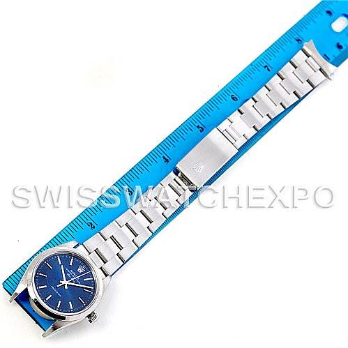 The Rolex Air-King 14000 Men's Stainless Steel Blue Dial 14000 Men's Stainless Steel Blue Dial watch is shown laid flat with its bracelet extended next to a blue ruler for measurement.