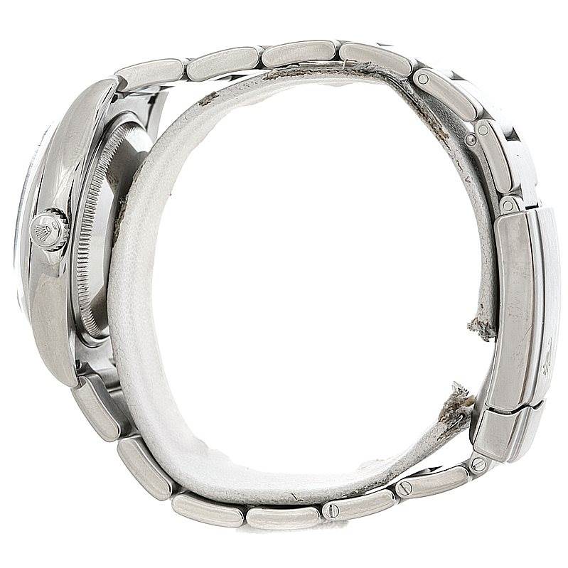 This side view of the Rolex Air-King 114200 Men's Stainless Steel Silver Dial 114200 Men's Stainless Steel Silver Dial watch showcases its case, crown, and stainless steel bracelet.