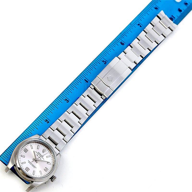 The image shows a Rolex Air-King 114200 Men's Stainless Steel Silver Dial 114200 Men's Stainless Steel Silver Dial watch laid flat with its face, band, and clasp visible next to a blue ruler.